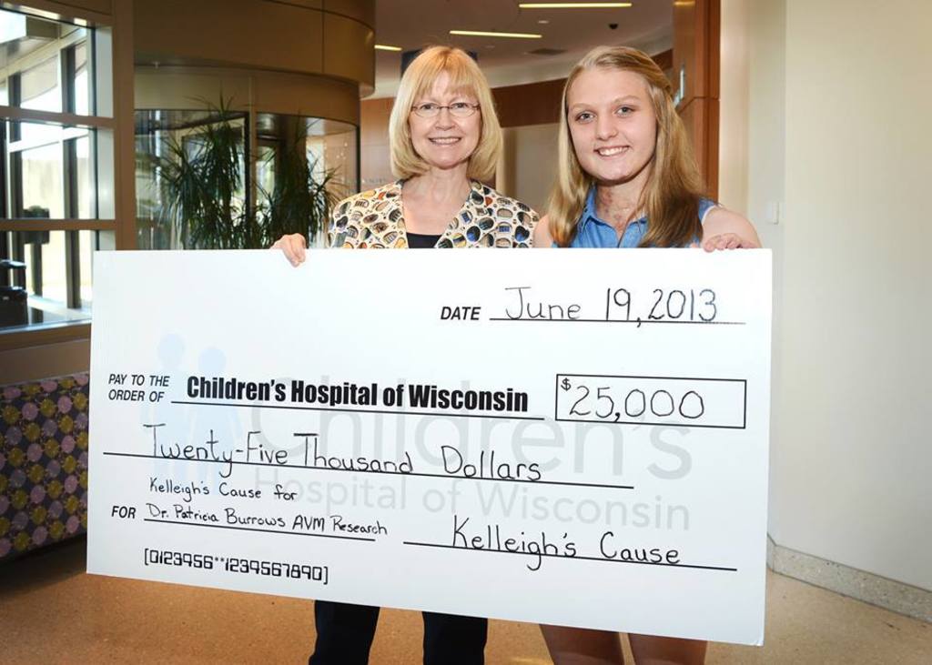 Kelleigh presented Dr. Burrows with a $25,00 check to support research for a cure for AVMs