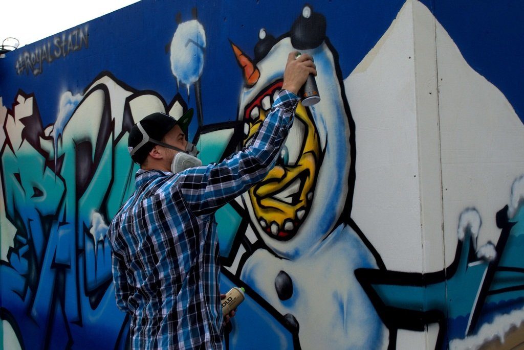 Royal Stain aka Tristan at work on his mural for Snowball 2014, photo by Lindsey Bartlett.