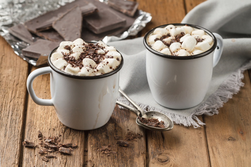 Hot chocolate with marshmallows in two enamel tin mugs