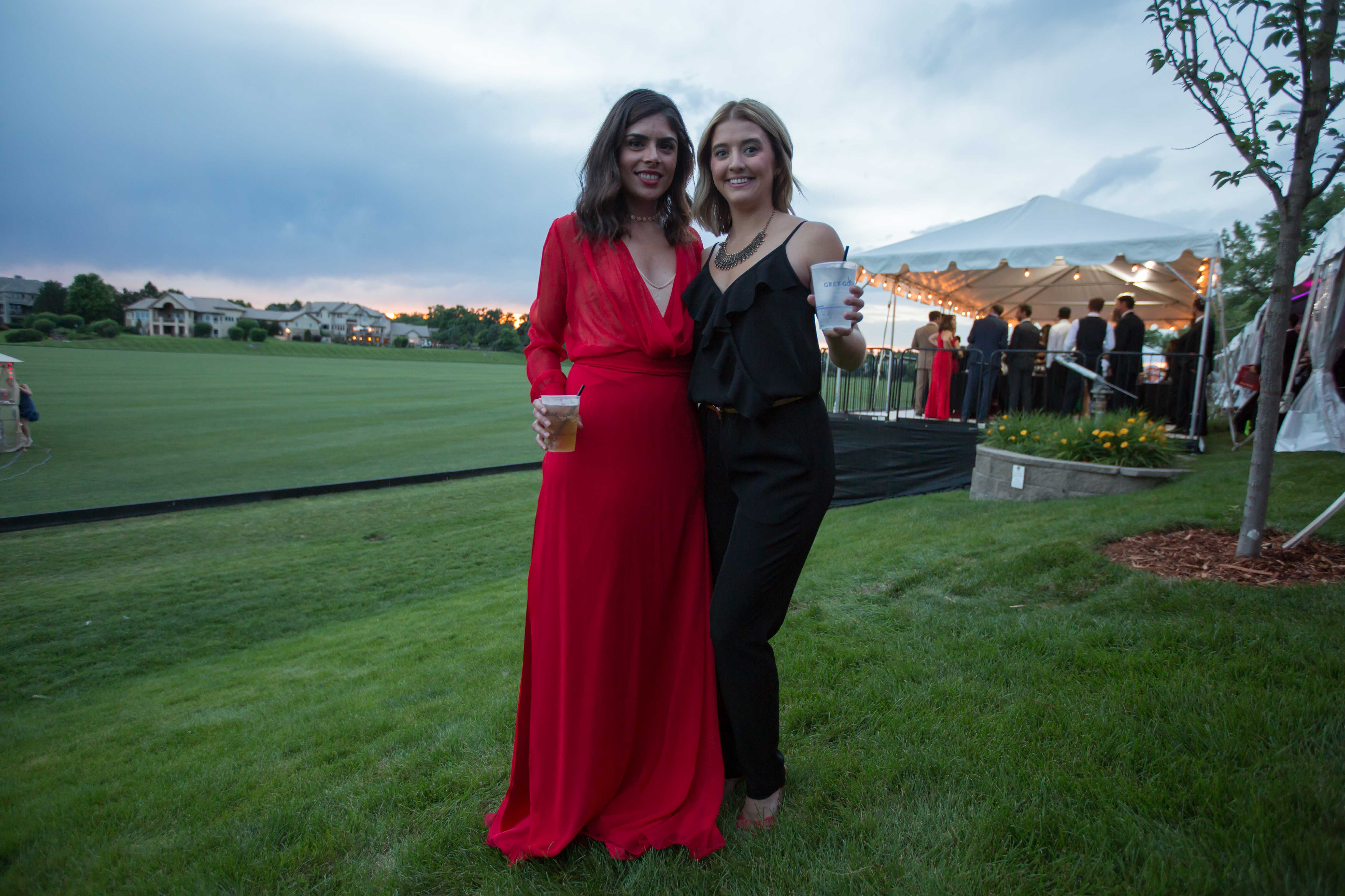 On the left, Veronika Pagan stuns in a red dress from Puerto Rican designer Nicole Vitier while Kady Gundlach rocks a black pantsuit from H&M.