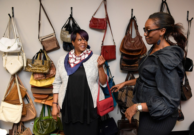 DENVER, COLORADO - OCTOBER 12: Amara Martin, right, Programs Director of Dress for Success Denver, helps client Kimberly Edwards, left, complete a professional outfit with a handbag at Dress For Success on October 12, 2016 in Denver, Colorado. Dress for Success helps to empower women to transform their lives. Their programs helps women achieve economic independence by providing attire and the development tools for women to thrive in work and in life. The 3 core principals that it offers are: Professional attire, career tools and support networks. The organization will be hosting it's annual fundraiser Winter Fashion Gala November 4th. (Photo by Helen H. Richardson/The Denver Post)
