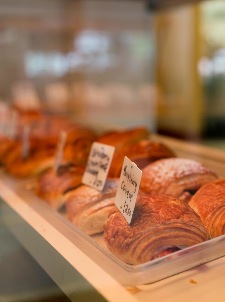 A display case filled with various croissant offerings.