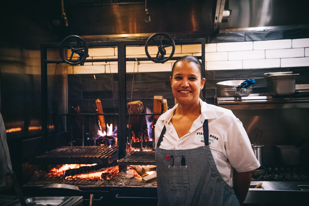 Executive chef Aniedra Nichols stands fireside Monday evening.