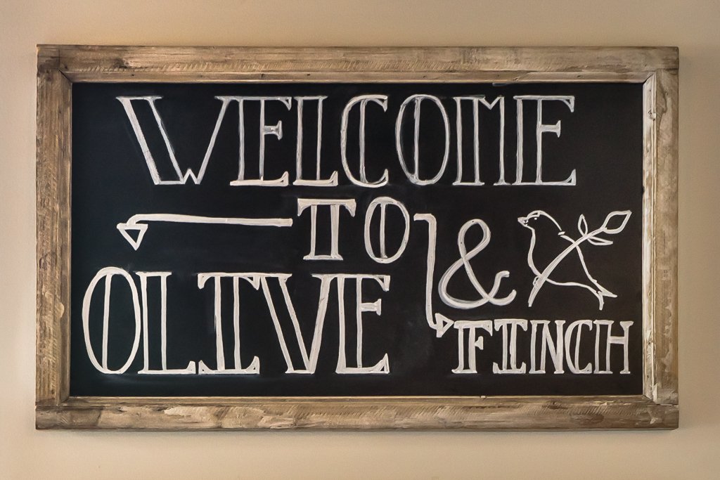 Welcome To Olive & Finch sign