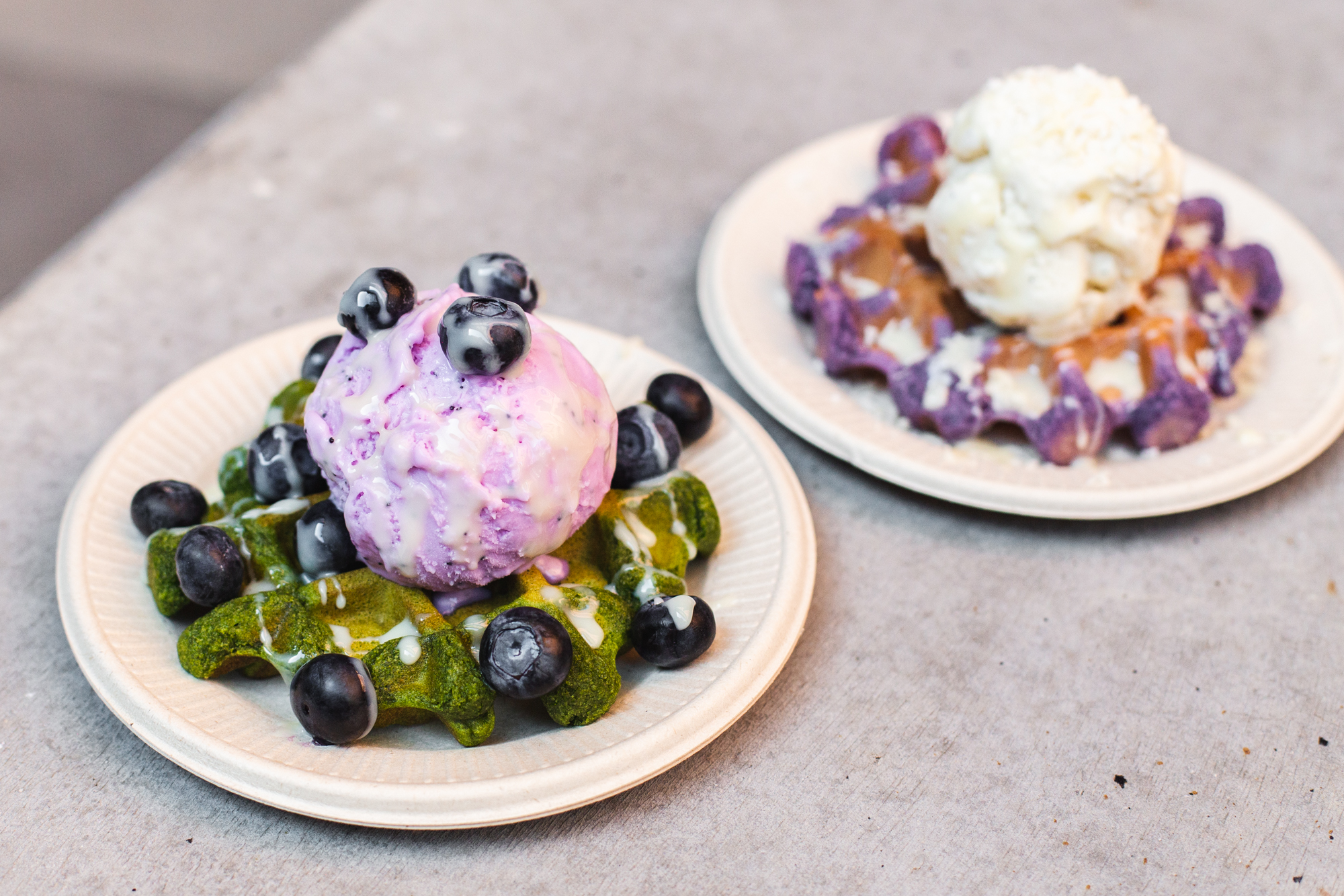 Taking a bite of a match mochi waffle with lavender ice ceam