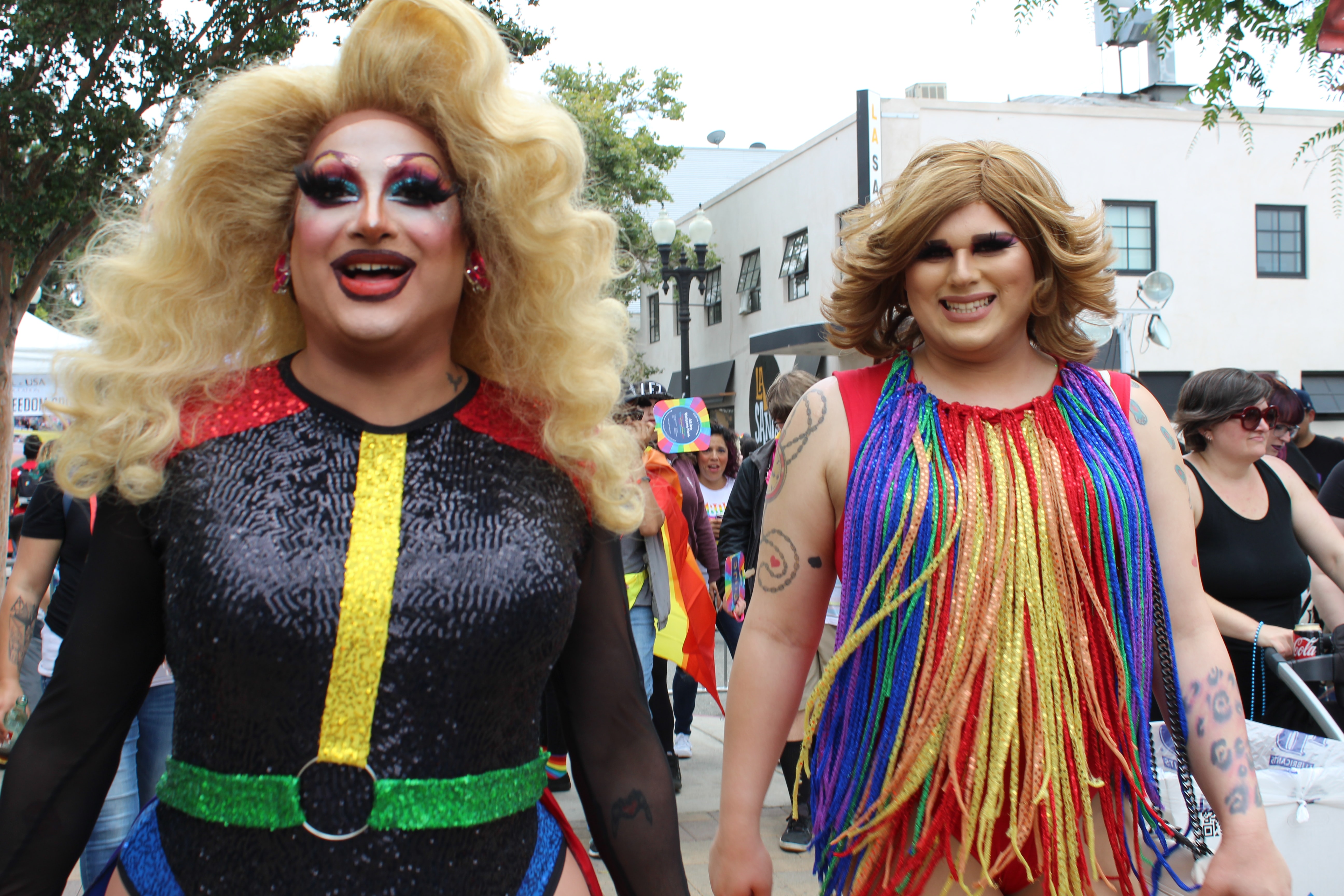 Two pride participants wearing drag outfits