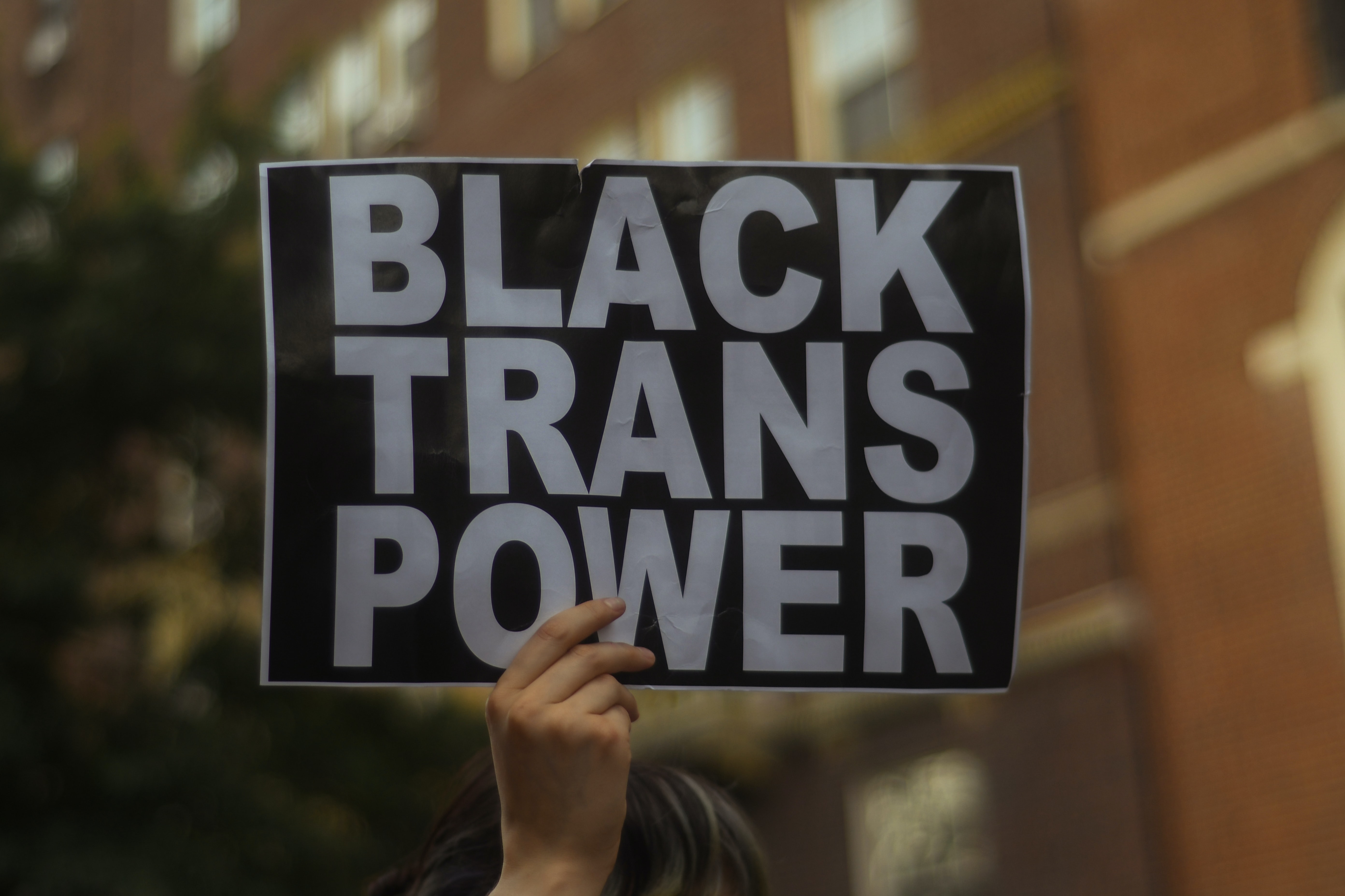 Protest sign reads "Black trans power'