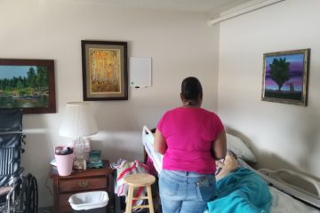 Staff member visiting resident in their room., Hospice