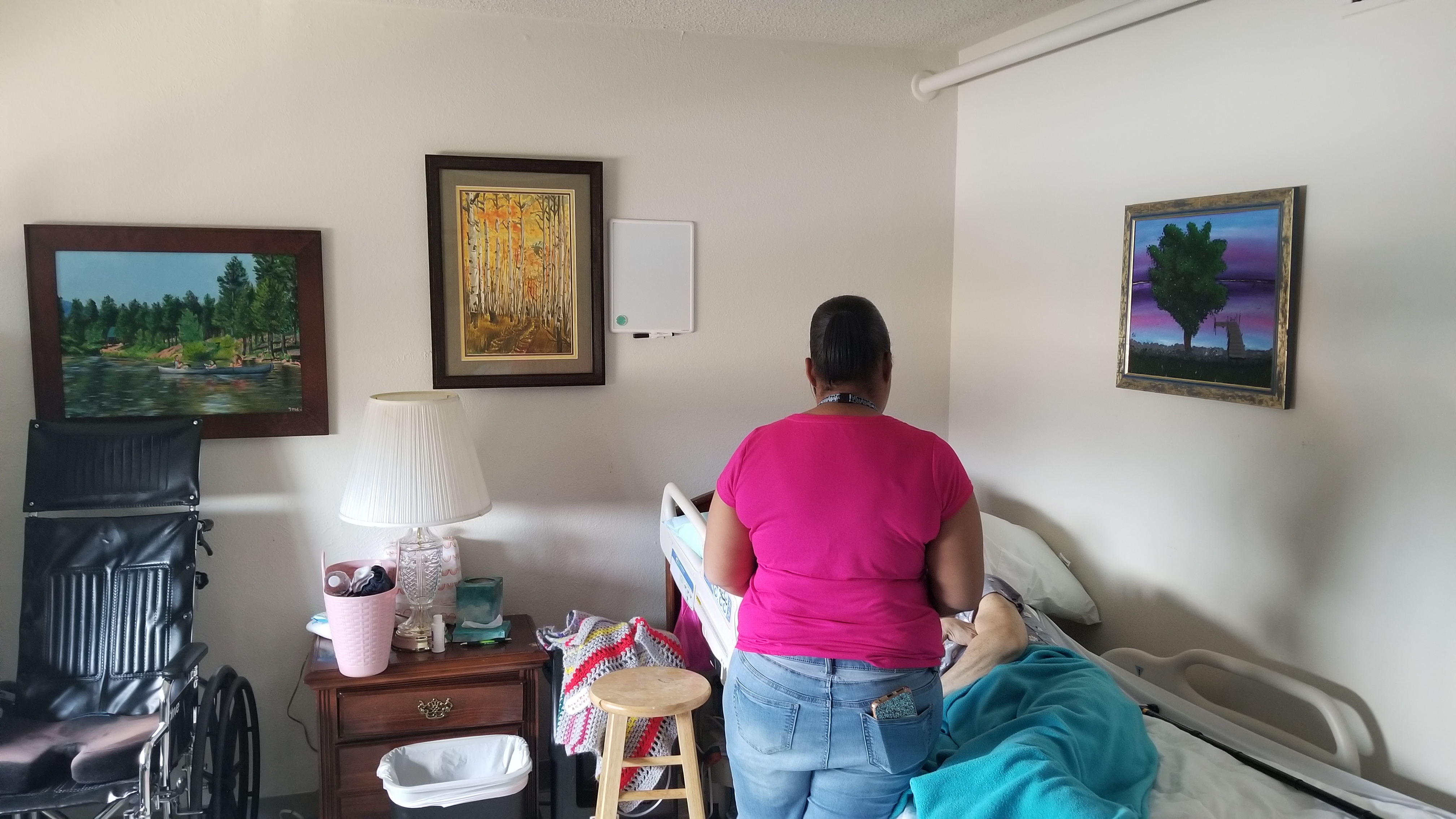 Staff member visiting resident in their room., Hospice