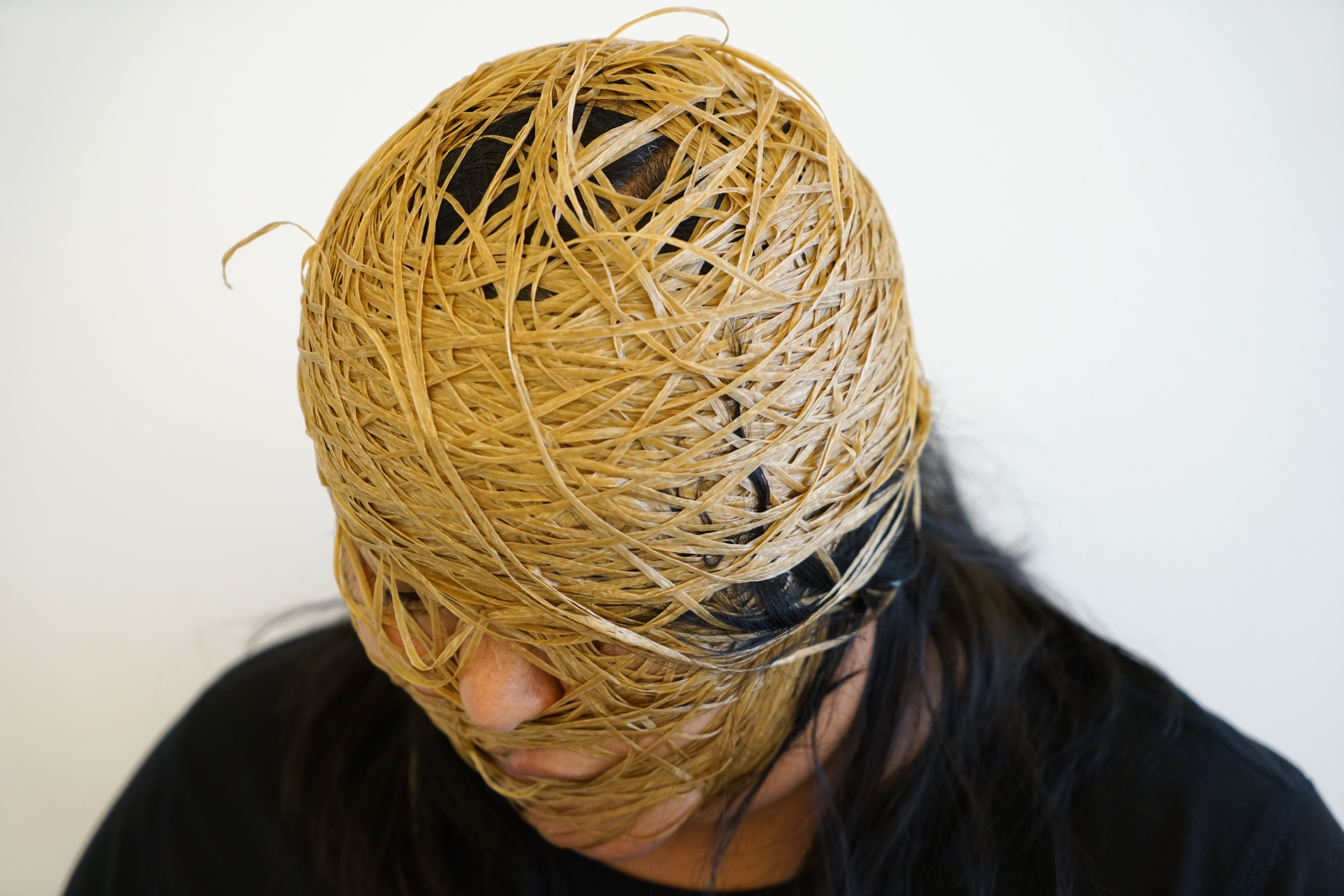 Anna Tsouhlarakis wrapped in twine in black t-shirt