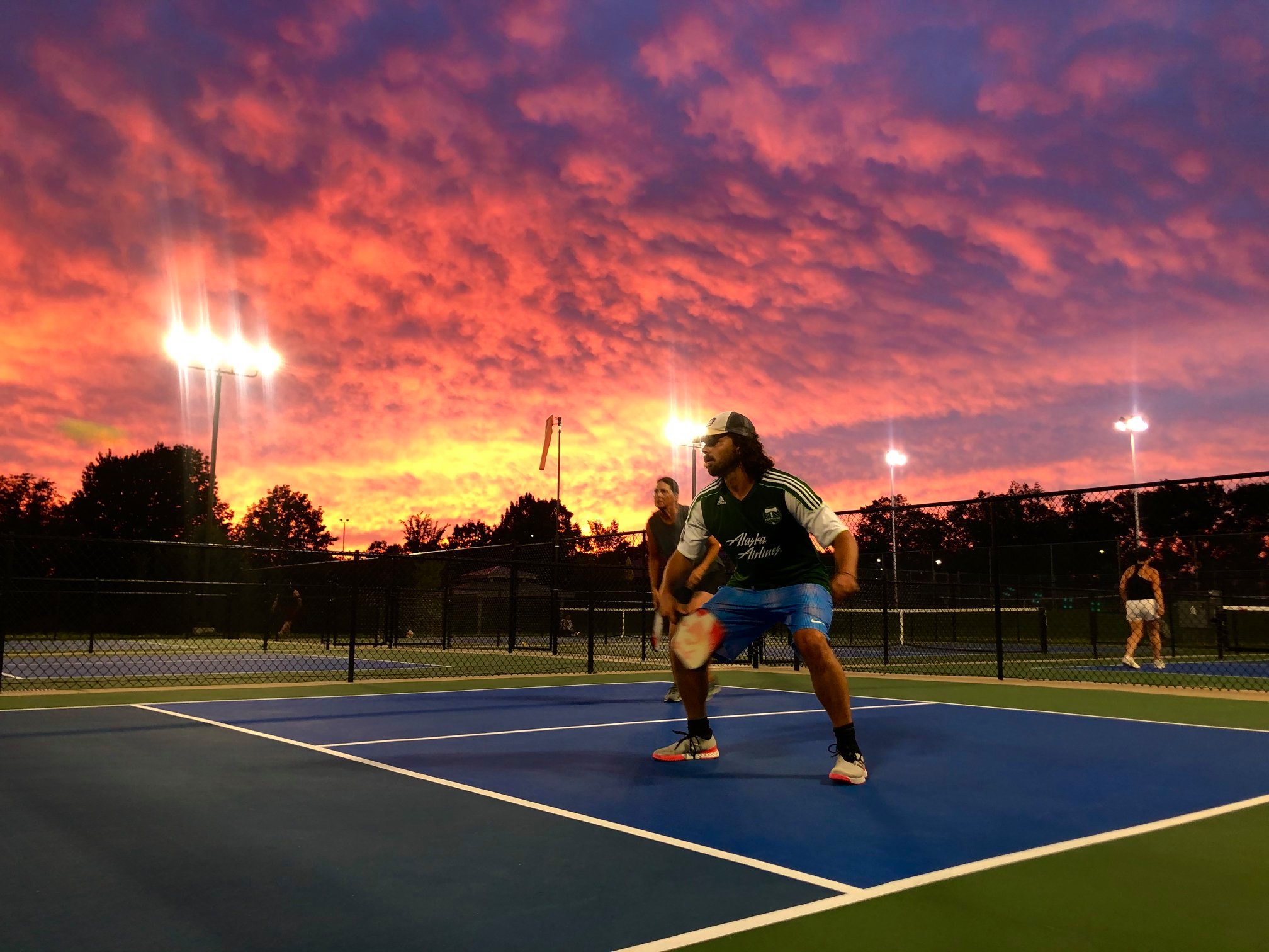 sunset with pickleball play with a Photo by Denver Metro Pickleball Association