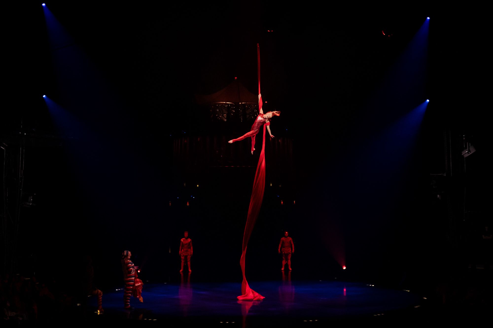 Person on red ribbon in air, Cirque du Soleil: Kooza Returns to Denver