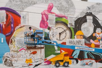 Artists working on a mural.