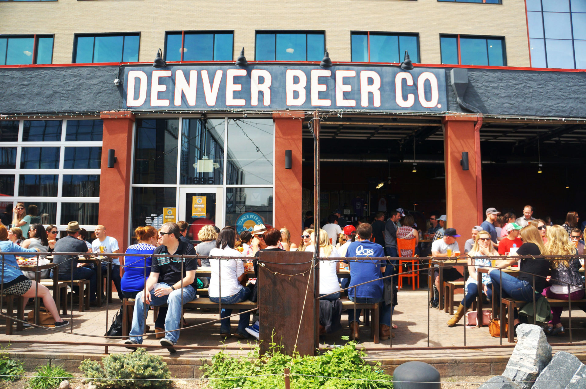 People socializing on the patio of Denver Beer Co.