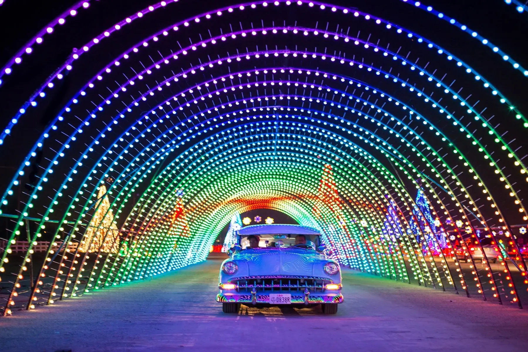 Car driving under holiday light display