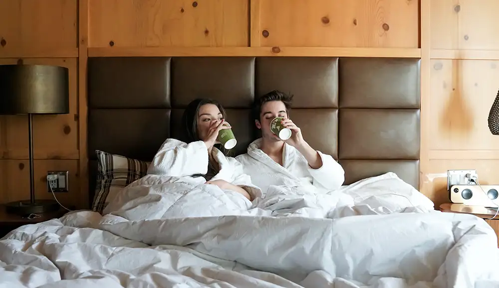 couple in bed, cups, Denver Hotel Valentine's Day