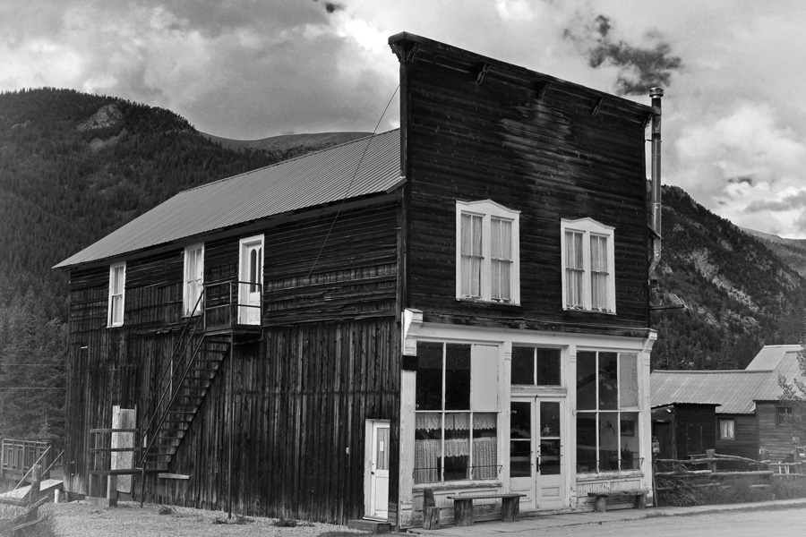 Black and white cabin, mountains outside