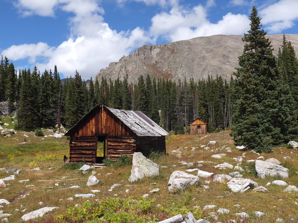 Outdoors, hut, trees, rocks, mountains