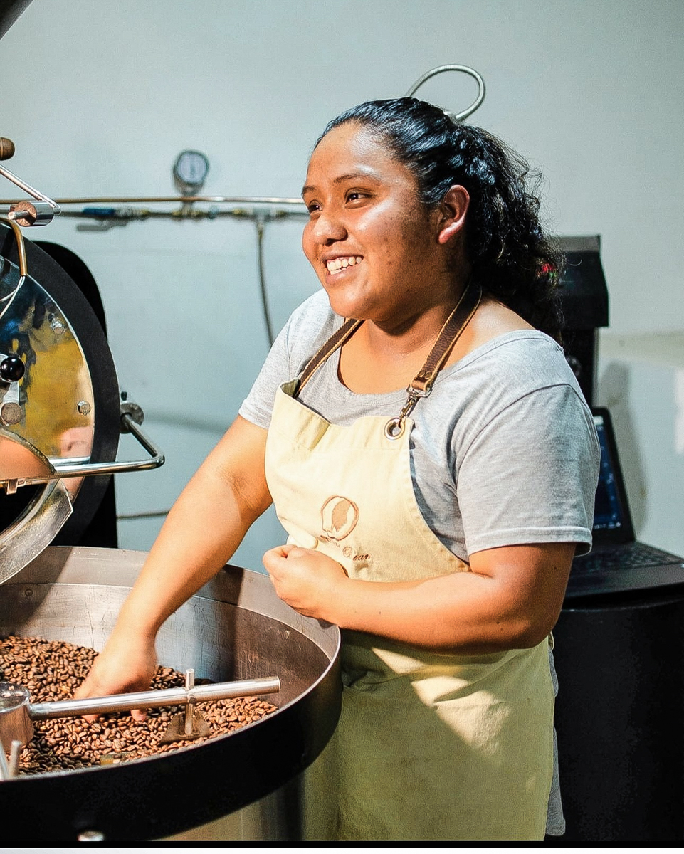 Image of woman stirring coffee beans